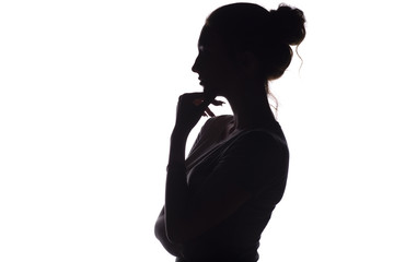 profile silhouette of a pensive girl with a hand at the chin, a young woman on a white isolated background