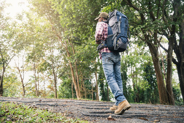 Man traveling with backpack hiking in mountains. Man backpacker hiking in mountains alone outdoor active lifestyle travel adventure vacations.