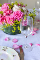 floral arrangement for interior decoration, table setting for a wedding or to create a home cosiness. use as background. pink roses