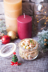 Traditional New Year and Christmas Russian salad Olivier (olivie) in a jar. Close-up, selective focus.