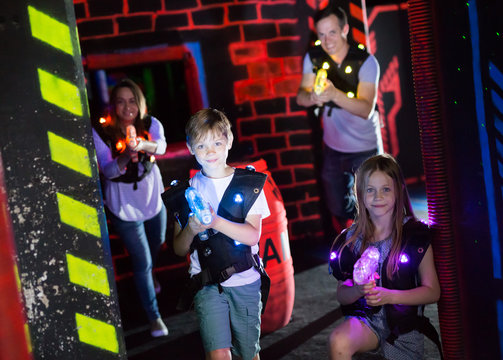 Brother and sister playing laser tag