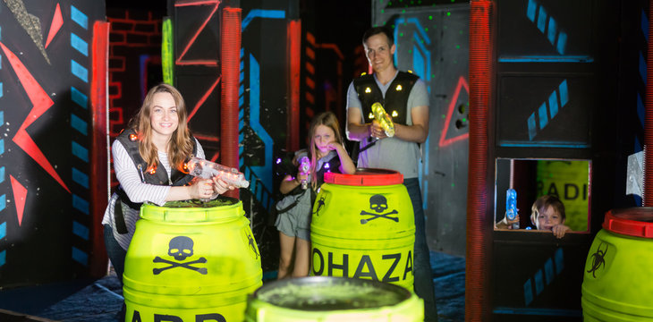 Woman playing laser tag with family