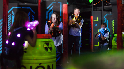 Fototapeta na wymiar Kids with parents during lasertag game