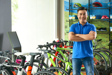 Confident smiling bicycle store shop assistant looking at camera © DragonImages