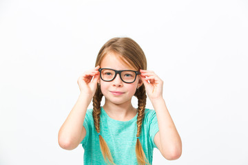 pretty girl with black glasses and plaits in front of white background in the studio