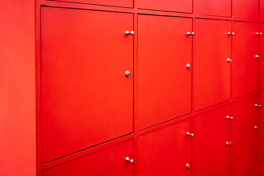 Red locker room with closed doors. Free service in fitness.