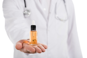 cropped view of male doctor holding bottle with cbd oil on hand isolated on white