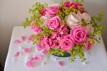 floral arrangement for interior decoration, table setting for a wedding or to create a home cosiness. use as background. pink roses
