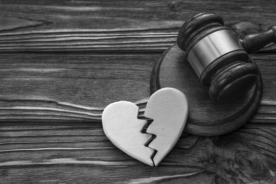 heart, the judge's gavel on wooden background table. family law, divorce and conflict.