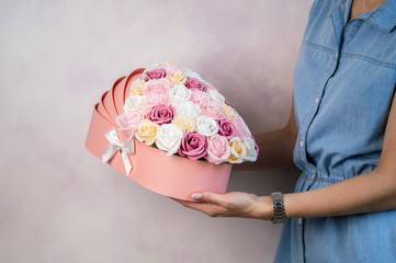 Congratulations on the birth of the baby: Pink box with multi-colored flower buds in the form of a...