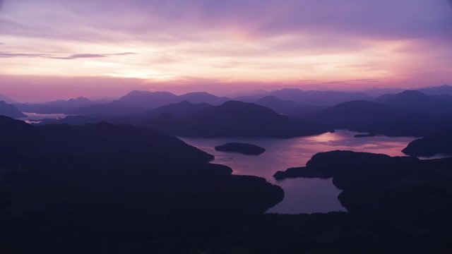 British Columbia circa-2018. Aerial view of lakes and hills at sunset.  Shot from helicopter with Cineflex gimbal and RED Epic-W camera.
