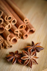  shelves of cinnamon and anise stars in dark backgrounds on a wooden background