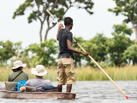 Local man working on Mokoro to deliver tourists and campers across the rivers of the Delta Okawango, Botswana