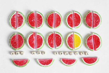 Picture to motivate unusual, distinguished people. The yellow slice of marmalade stands out among the many red ones