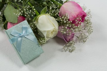 Fototapeta na wymiar Flower bouquet and gift on white background