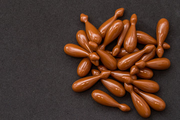 Brown capsules isolated on black background