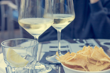 Outdoor street cafe table with finger food and local wine.