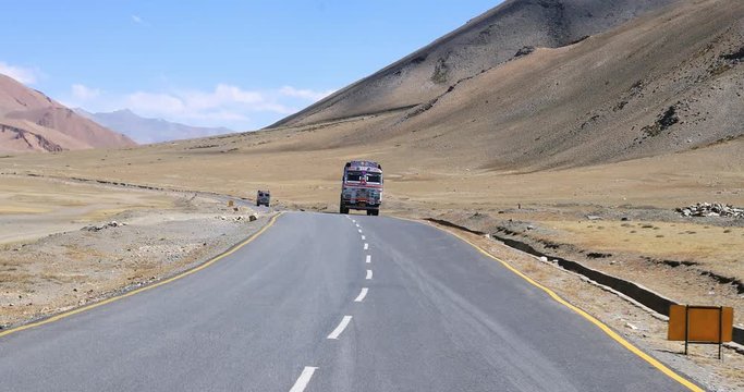 Truck travels through Himalaya mountains in India highland road way
