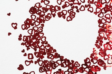 Heart shape decorations arranged on white background