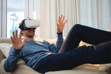 Man using virtual reality headset in living room