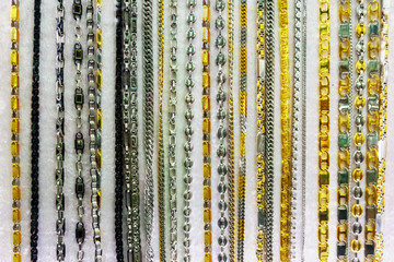 Gold and silver chains, women's jewelry in the shop window in Turkey.