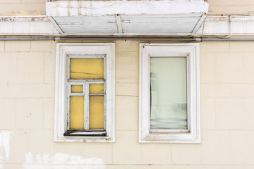 two old Windows in an old house under the balcony roof