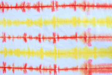 striped tie dye pattern hand dyed on cotton fabric abstract background.