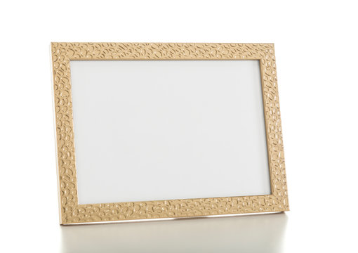 Gold colored desktop picture frame, blank picture area isolated with clipping path