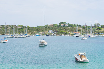 Obraz premium A lot of sailboats anchored in a port outside the city