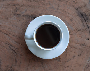 Coffee in a white cup on a wooden table