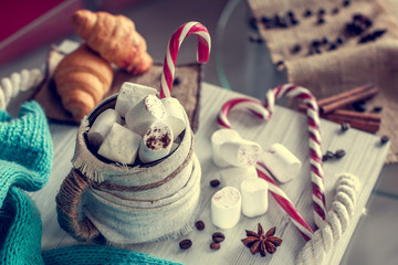 cozy winter still life, consist of, cup of coffee with marshmallow, croissants and striped lollipops