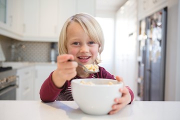 Boy having his breakfast at home