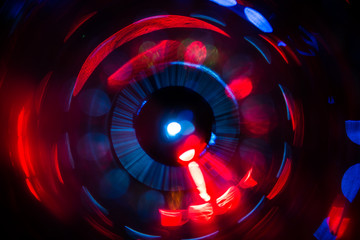 Abstract photo of blurry light sources of different colors twisted into a circle