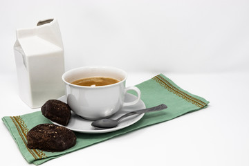 Traditional Italian breakfast with coffee and milk, cappuccino and homemade chocolate biscuits. White ceramic cups on a white background. Wake up early in the morning.