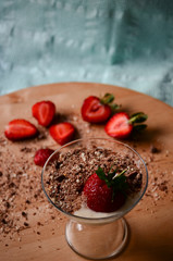Strawberry pudding with fresh strawberries on wooden plate