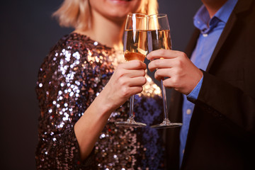 Picture of couple with champagne glasses with champagne on black background