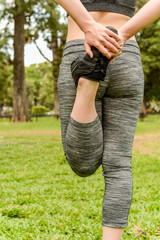 close up view of sport woman streching legs