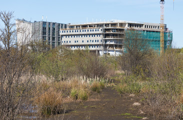 Abandoned environment, new city rises in the distance.