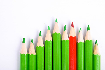 Many different colored pencils on a white background with a place for text and cory space .