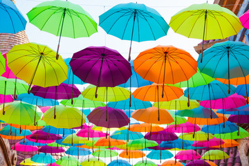 Fototapeta na wymiar colorful umbrellas hanging on the sky
