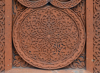 Traditional tufa stone carving ornament on a wall of Armenian Orthodox Church