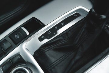 Fototapeta na wymiar Automatic gear stick inside modern luxury car