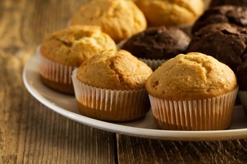 Chocolate cake and nut cake, homemade cakes on wooden background