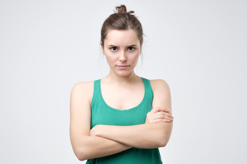 Pissed off woman, crossing hands, looking with angry expression, being offended
