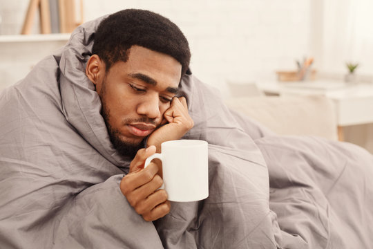 Cold Black Man With Flu Wrapped In Warm Blanket