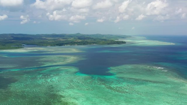 Aerial view of seascape near Ngerulmud, crystal clear waters of Pacific Ocean, colorful coral reefs, many shades of turquoise and blue - landscape panorama of Micronesia from above, Palau