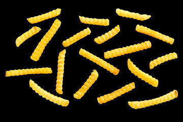 Fusilli pasta on black background