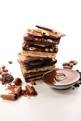 Chocolate bars on table with chocolate tower.