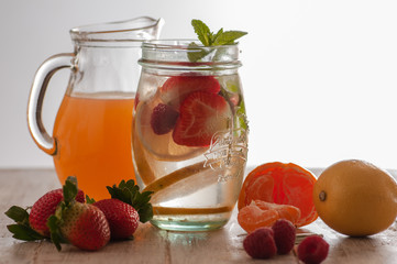 Fresh drink with strawberries, lemon and mint. Serving on a wooden table