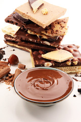 Chocolate bars on table with chocolate tower.